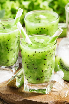 Fresh green juice with kiwi and ice, selective focus