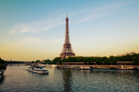 Eiffel Tower with boats in evening Paris, France