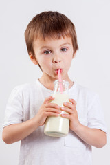 Cute little boy, drinking milk, holding glass of milk, mustaches
