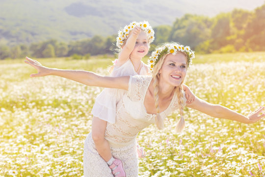 Happy family in field of daisy flowers