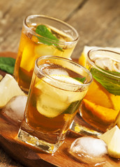 Fresh Cold black tea with lemon, mint and ice selective focus