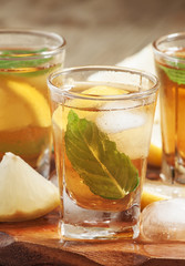 Fresh Cold black tea with lemon, mint and ice selective focus
