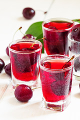Fototapeta na wymiar Fresh cherry juice with berries, selective focus
