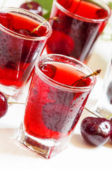 Fresh cherry juice with berries, selective focus