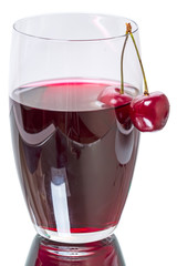 Glass of cherry juice with cherries
