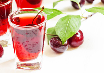 Fresh cherry juice with berries, selective focus
