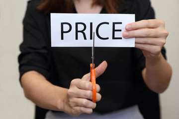 woman cutting paper of price word