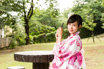 Asian woman in Japanese garden