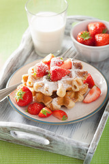 belgian waffles with icing sugar and strawberry