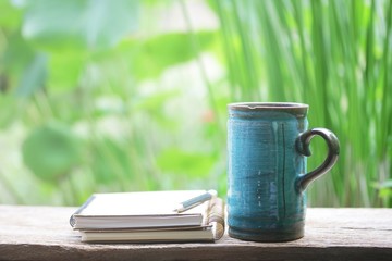 Notebook  and  blue mug on wooden table