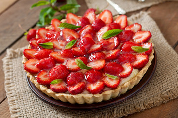 Tart with strawberries and whipped cream decorated with mint leaves - Powered by Adobe