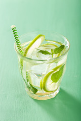 fresh mojito cocktail over green background