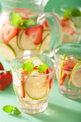 refreshing summer drink with strawberry cucumber lime in jar and