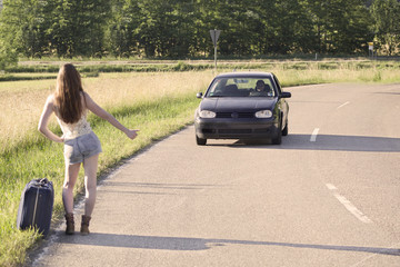 Beautiful young redhead woman waiting for a ride