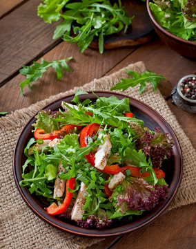 Dietary salad with chicken, arugula and sweet red pepper