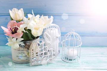 Background with fresh narcissus, tulips, candle and heart