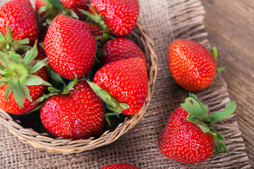 Fresh red strawberries on old wooden background