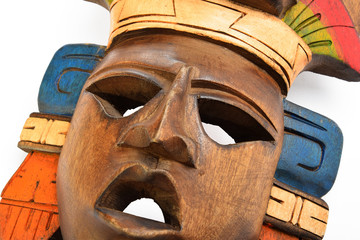 Indian Mayan Aztec wooden painted mask with roaring jaguar and human profiles isolated on white background (close up cut) © breakingthewalls