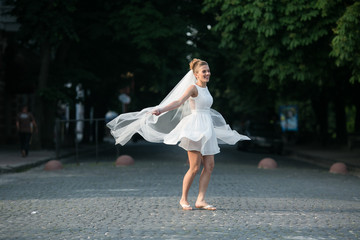 Fototapeta na wymiar Bride jumps with vail
