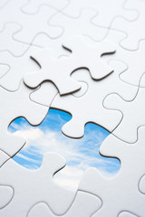 Jigsaw piece with sky in hole, conceptual image