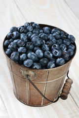 Bucket of Blueberries on Rustic Table