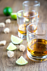 Glass of rum on the wooden background