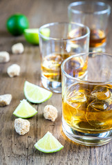Glass of rum on the wooden background