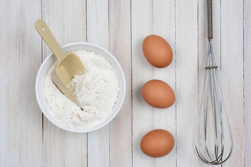 Bowl of Flour Eggs and Whisk