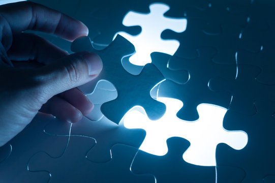 Hand insert jigsaw, conceptual image of business strategy, decis