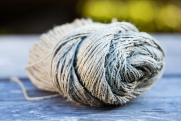 A ball of a string or rope on a wooden bench in the garden