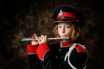 girl in a marching band uniform with a flute © sianc