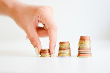 Graph chart coin pile suggesting a money scale