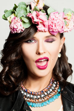 Beautiful Fashion Woman Winking. Makeup, Hairstyle, Flowers. Fun