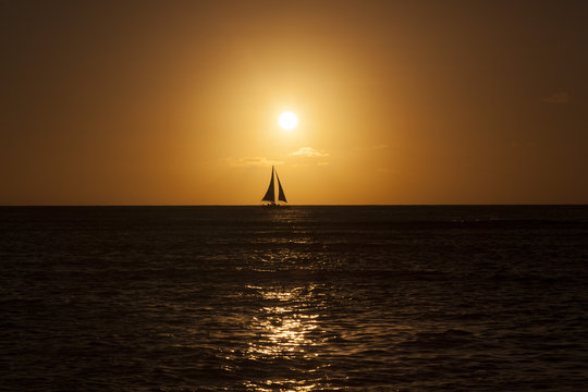 Fototapeta Yacht sailing on Pacific Ocean during sunset