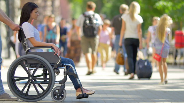 4 in 1 video! The man carry disabled woman in the wheelchair - they are happy: laugh and ride in the crowd stream at sidewalk