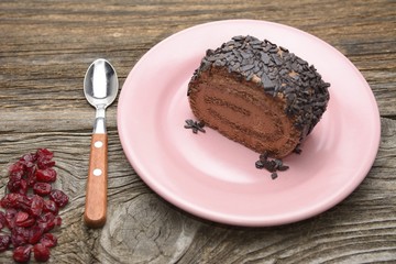 Roll of chocolate cake with craberry