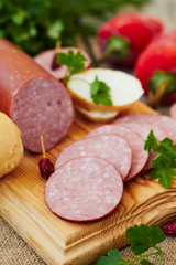 Salami sausage sliced with herbs
