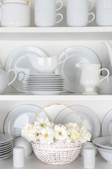 White Plates in Cupboard With Roses