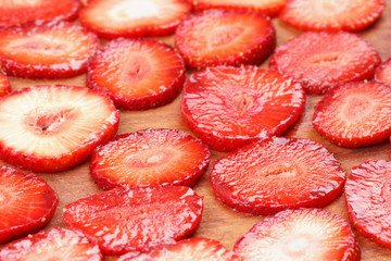 Cut strawberries on wood board