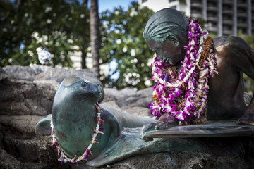 Surfer and Monk Seal statue in Waikiki, Hawaii
