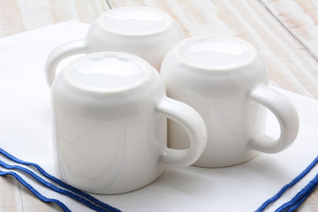 Three White Cups on Bar Towel