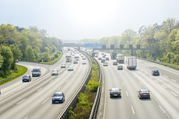 General view of a highway with cars and truck traffic