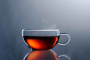 tea in glass cup on grey background