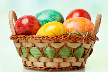 Colorful painted easter eggs in basket