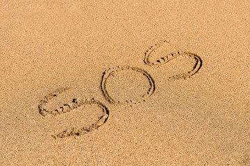 SOS Help Cry For Help Written On Beach Sand