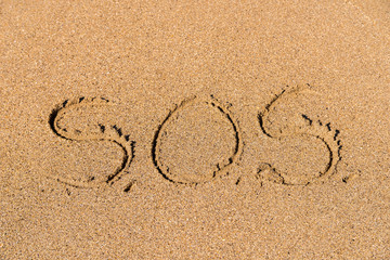 SOS Help Cry For Help Written On Beach Sand