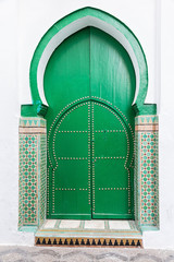Ancient green wooden door leading to a mosque. - 85205061