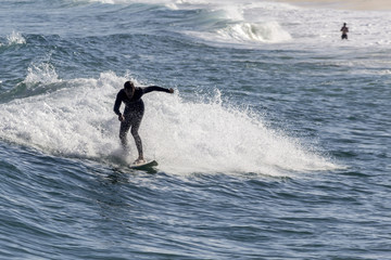 Ocean view and people surfing in Tavira Island beach, Algarve