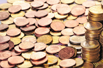 Euro coins on banknote money background