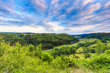 Fototapeta na wymiar Stunning Summer Evening Landscape in the rural Countryside of Bamberg. Lovely green and blue colors near a picturesque country road